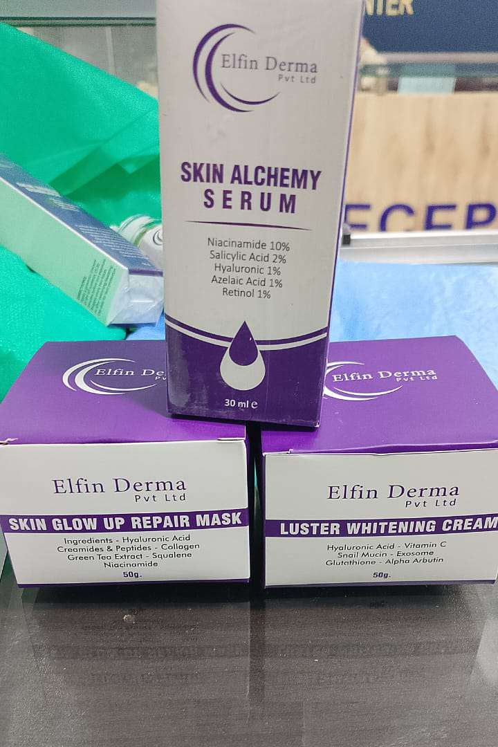 Elfin Derma skincare products including serum, mask, and cream on a reflective surface.