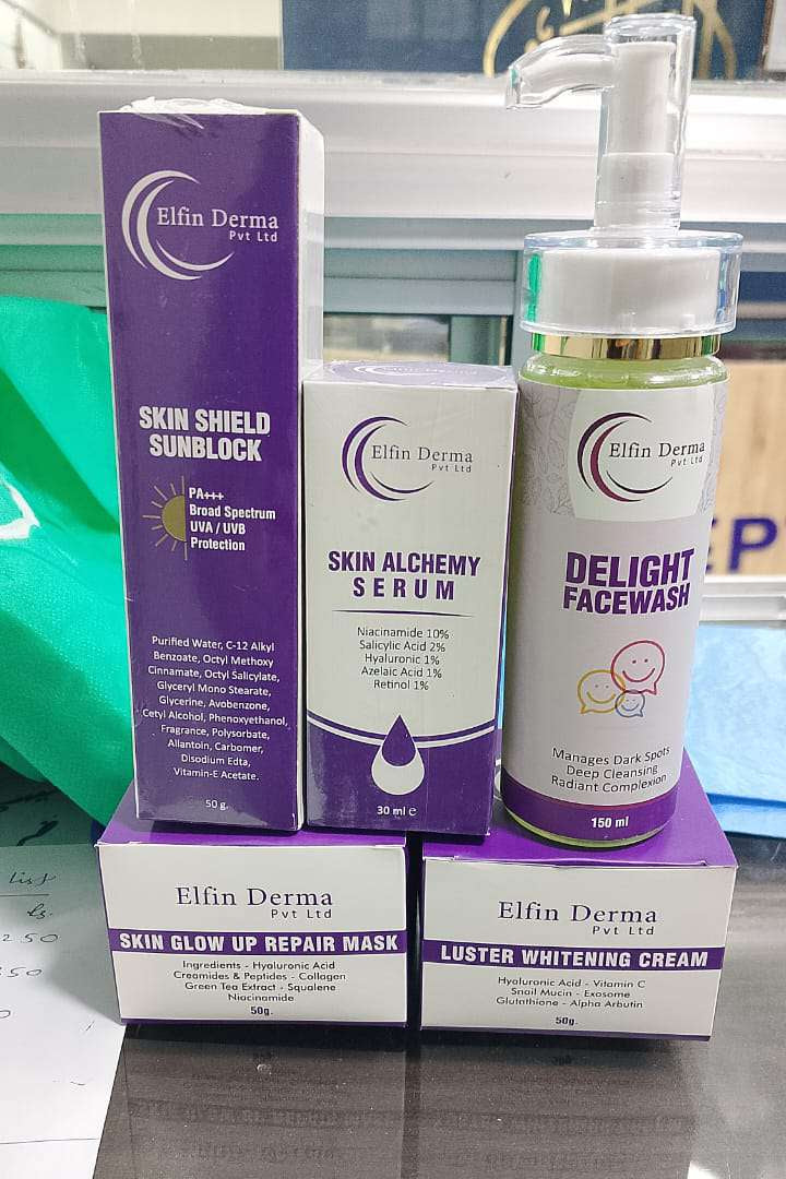 Elfin Derma skincare products including serum, face wash, and cream on a reflective surface.